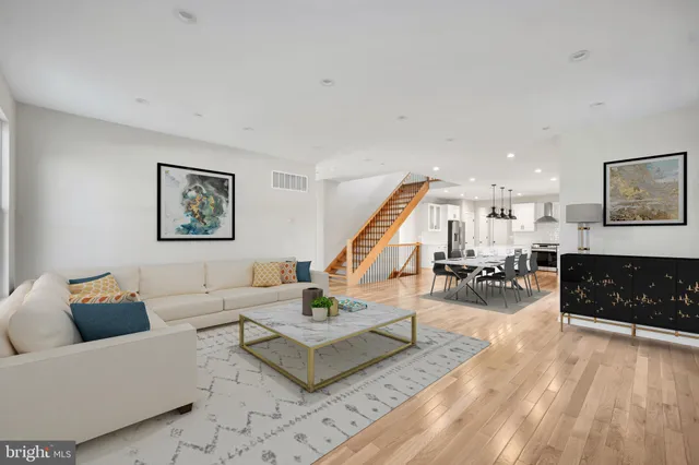 a spacious bedroom with a bed and a wooden floor