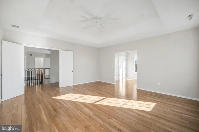a view of hallway with wooden floor
