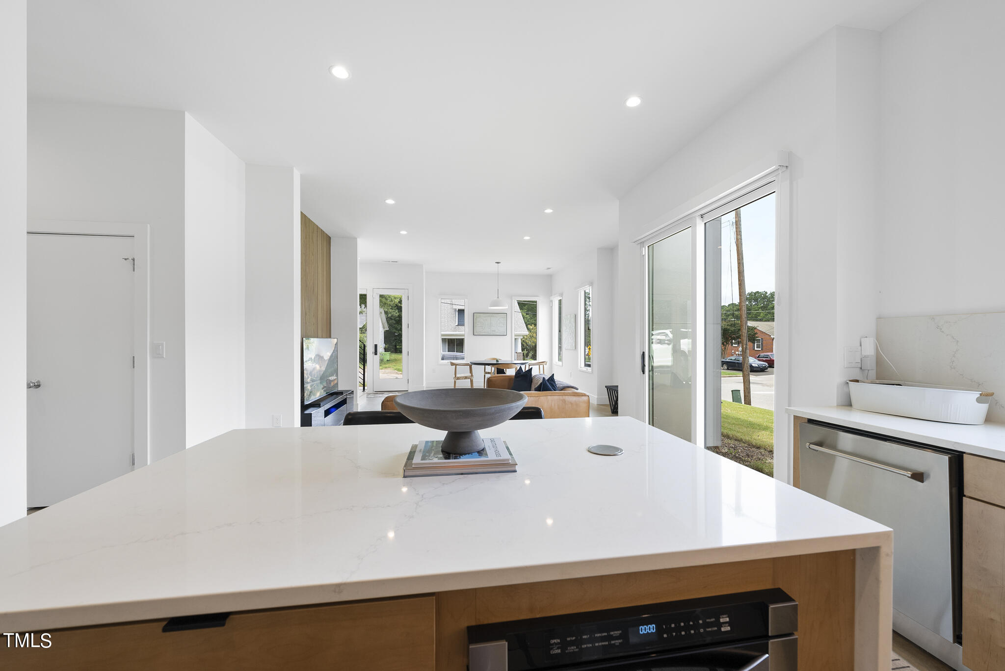 1012 Parker Street Raleigh, NC 27607 - Photo 16 of 39 a large white kitchen with a stove a sink a dining table and chairs