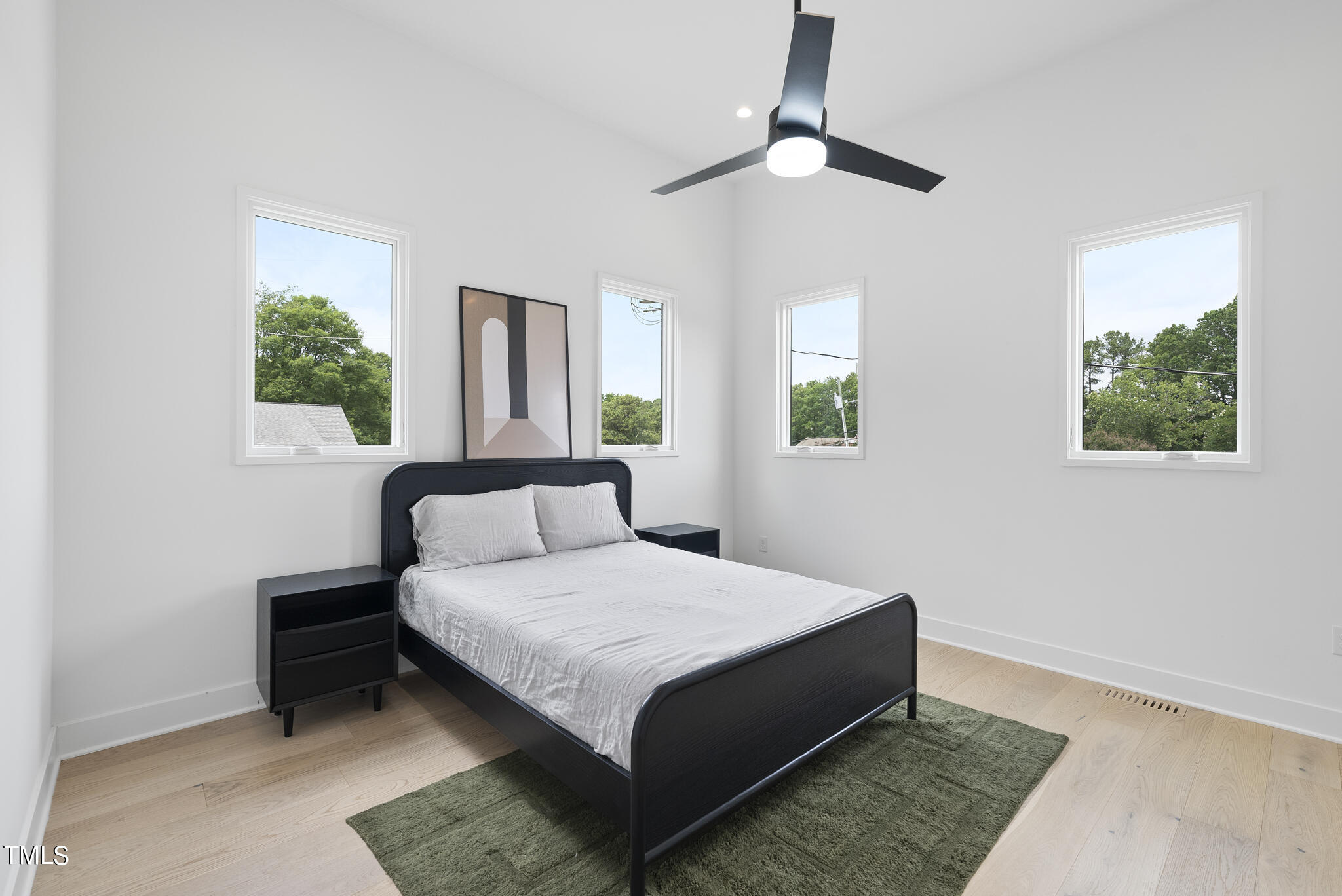 1012 Parker Street Raleigh, NC 27607 - Photo 24 of 39 a bedroom with a bed lamp and a window