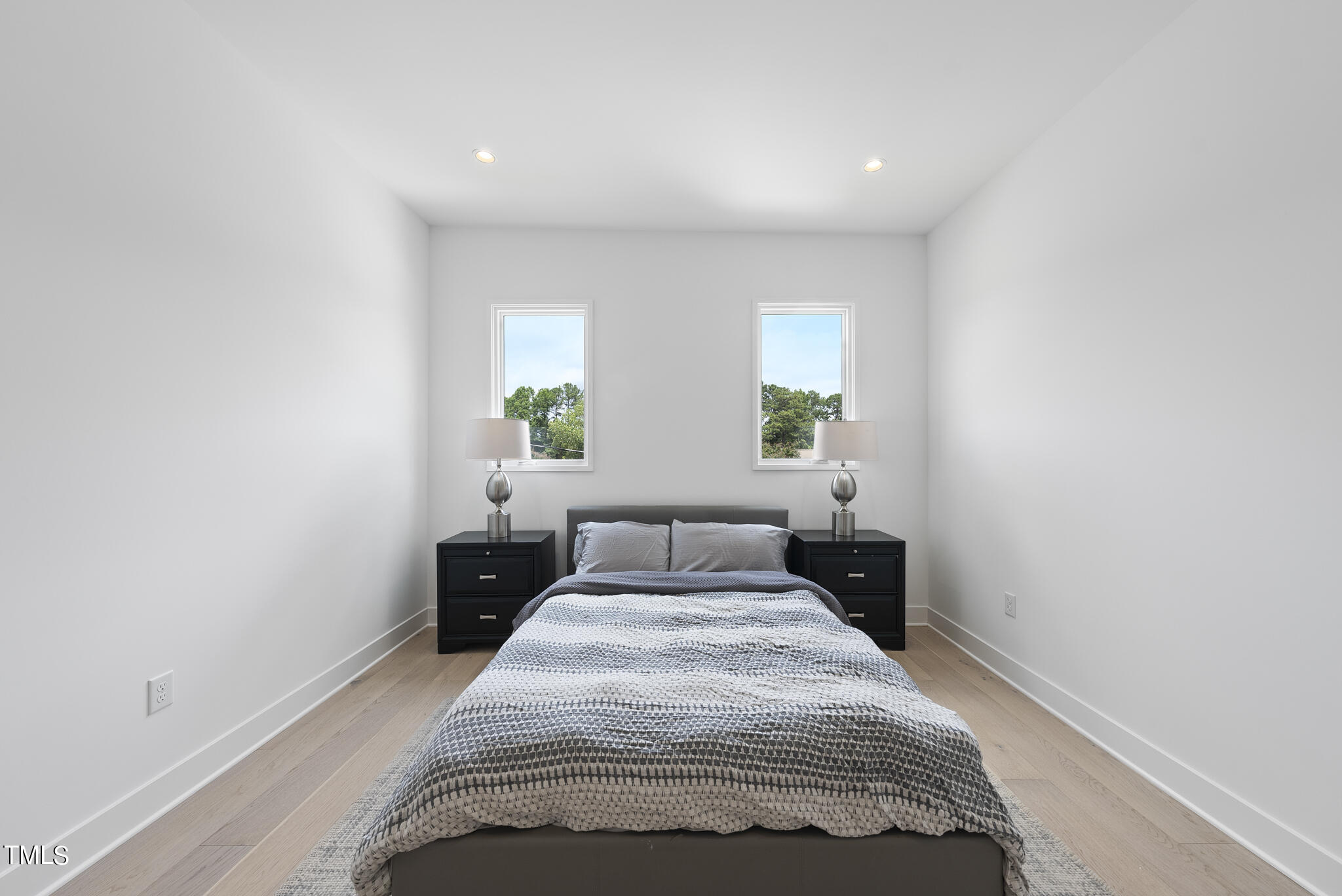 1012 Parker Street Raleigh, NC 27607 - Photo 33 of 39 a bedroom with a bed and wooden floor
