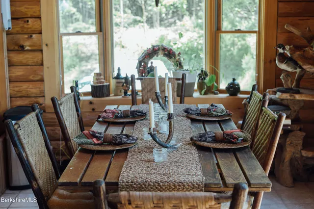 a living room with furniture and floor to ceiling windows