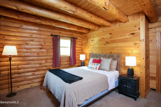 a bedroom with a bed and a lamp