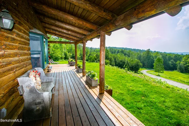 a view of balcony with wooden floor and outdoor seating
