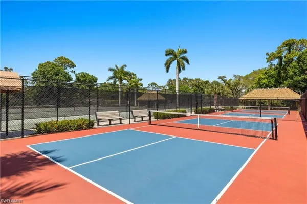 a view of a tennis court with sitting area