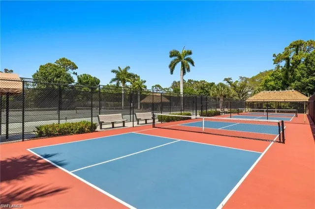 a view of a tennis court with sitting area