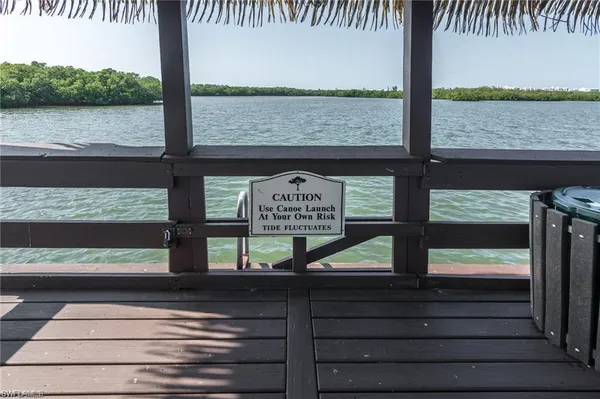 a view of wooden balcony with a lake