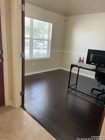 a view of workspace with wooden floor and windows