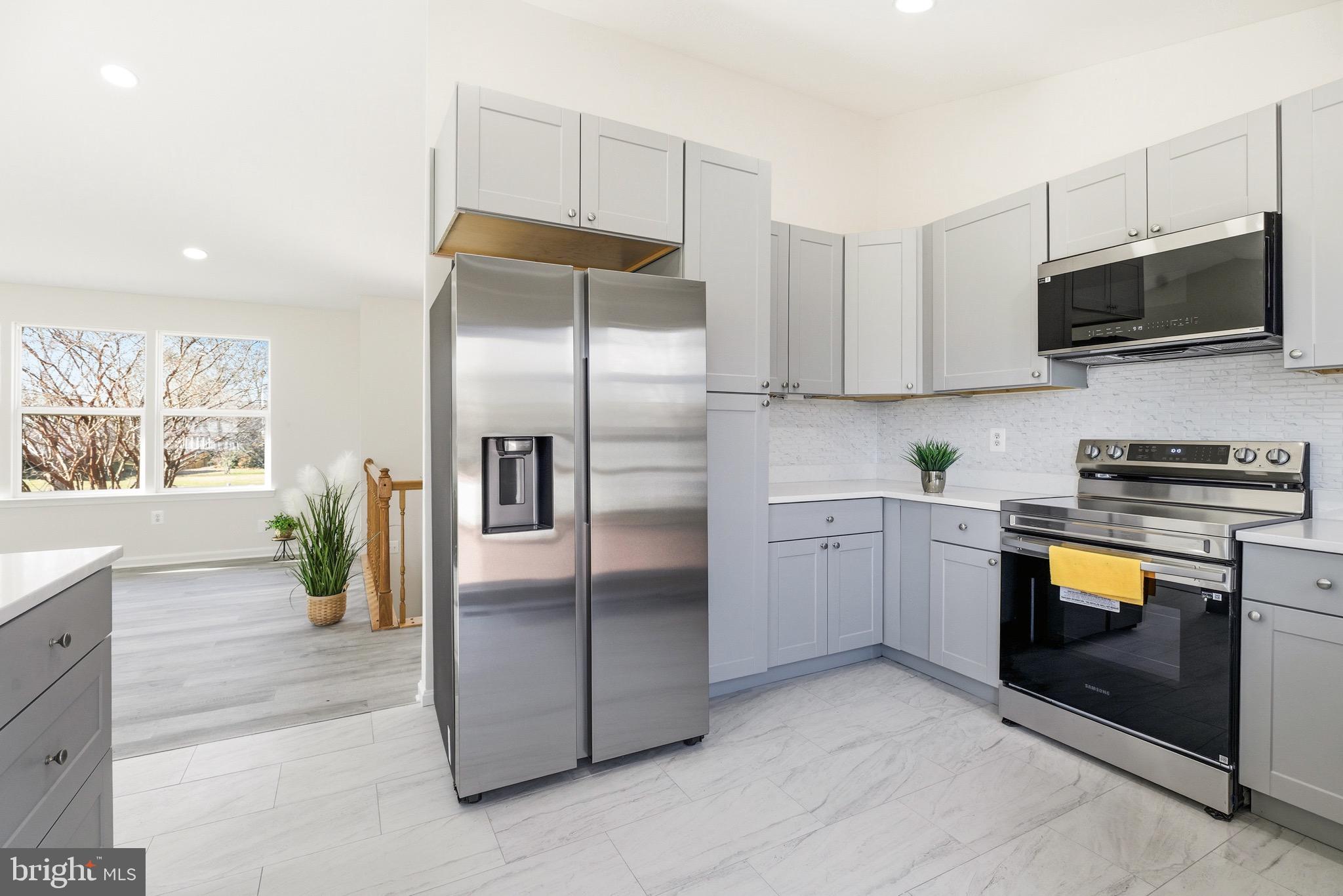 10395 Janja Court Manassas, VA 20110 - Photo 11 of 44 a kitchen with a refrigerator and a stove top oven