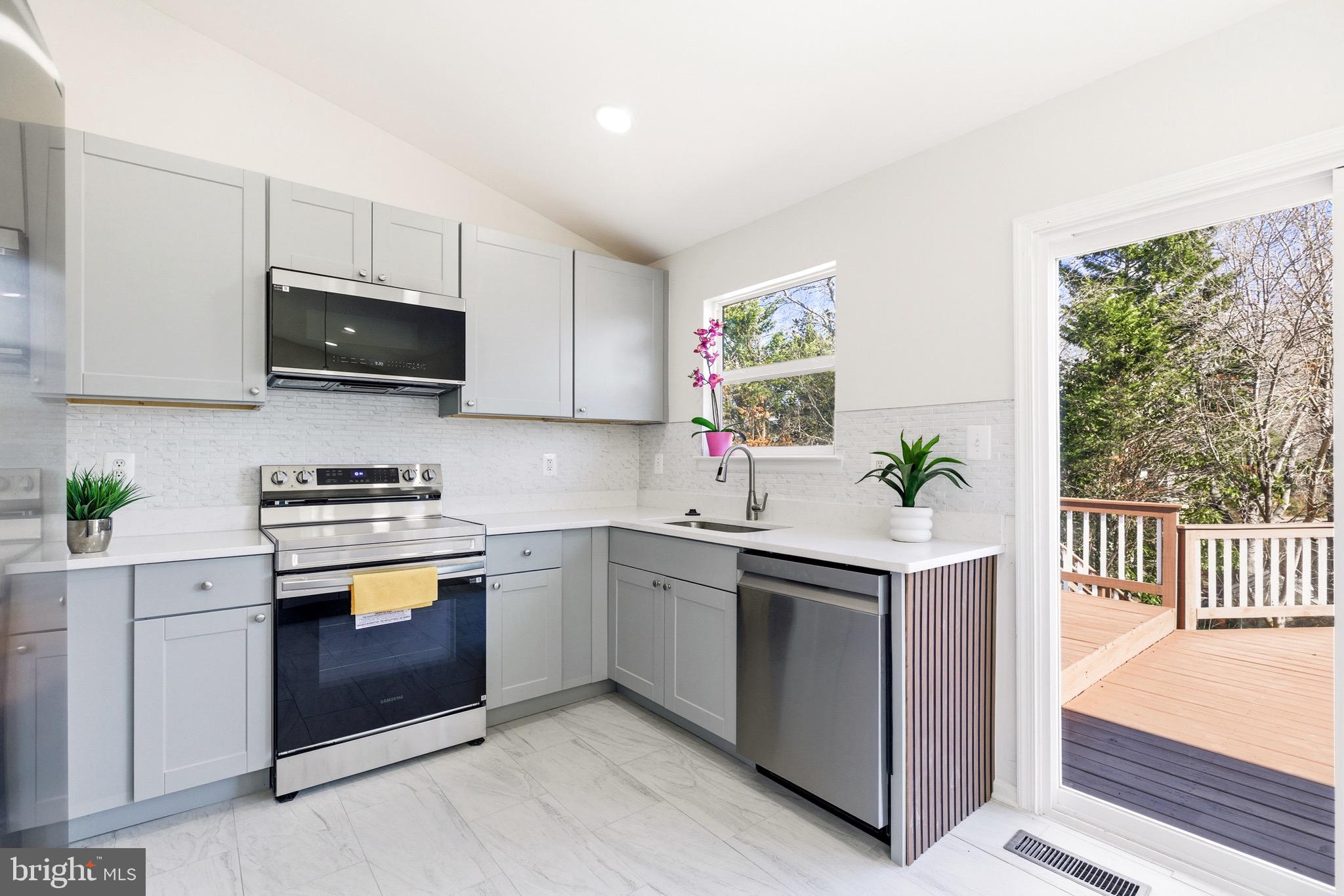 10395 Janja Court Manassas, VA 20110 - Photo 13 of 44 a kitchen with a sink stove and microwave
