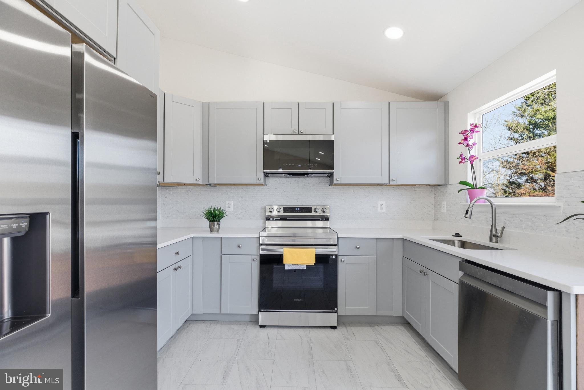 10395 Janja Court Manassas, VA 20110 - Photo 14 of 44 a kitchen with stainless steel appliances a stove sink and refrigerator