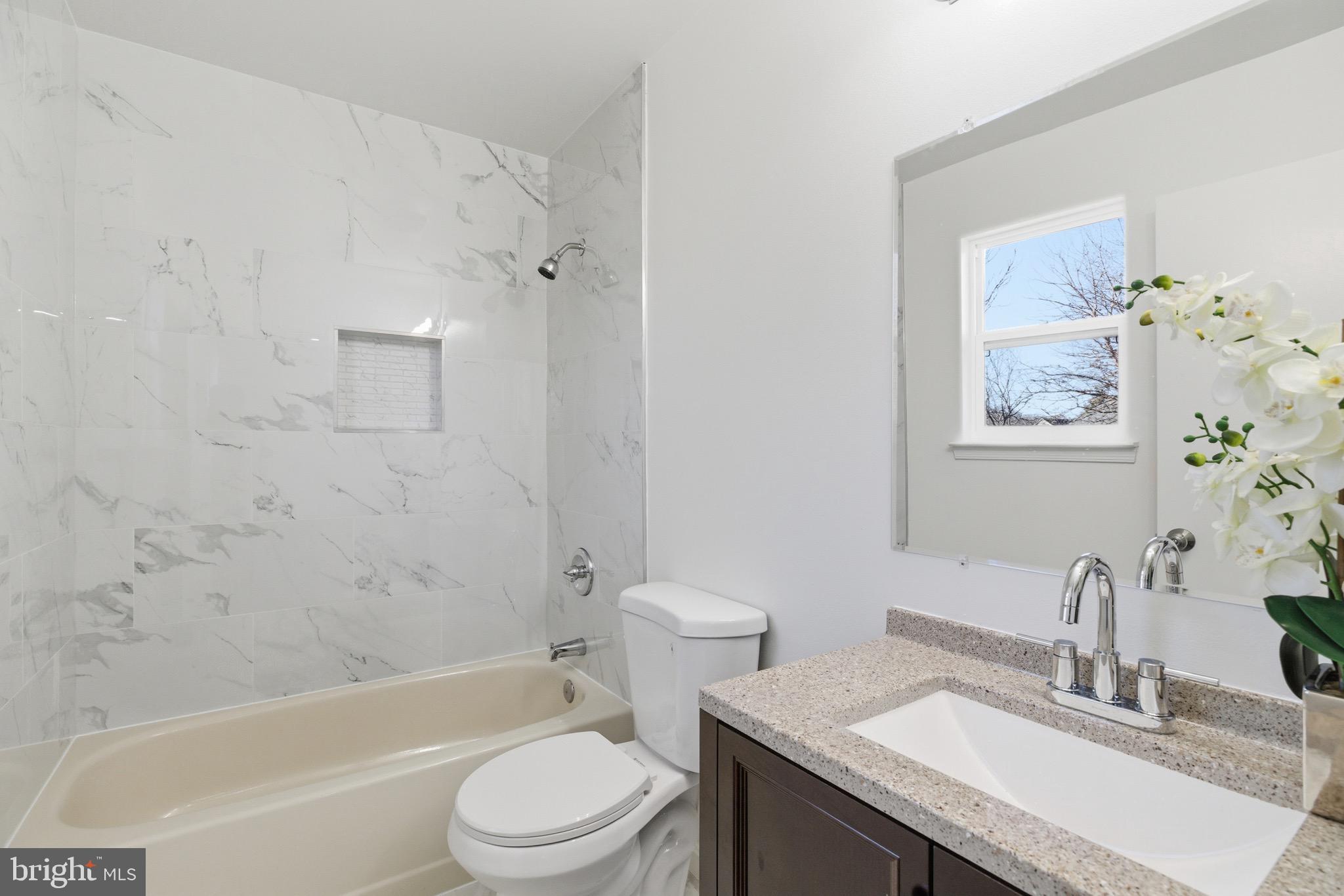 10395 Janja Court Manassas, VA 20110 - Photo 18 of 44 a bathroom with a granite countertop sink toilet and shower