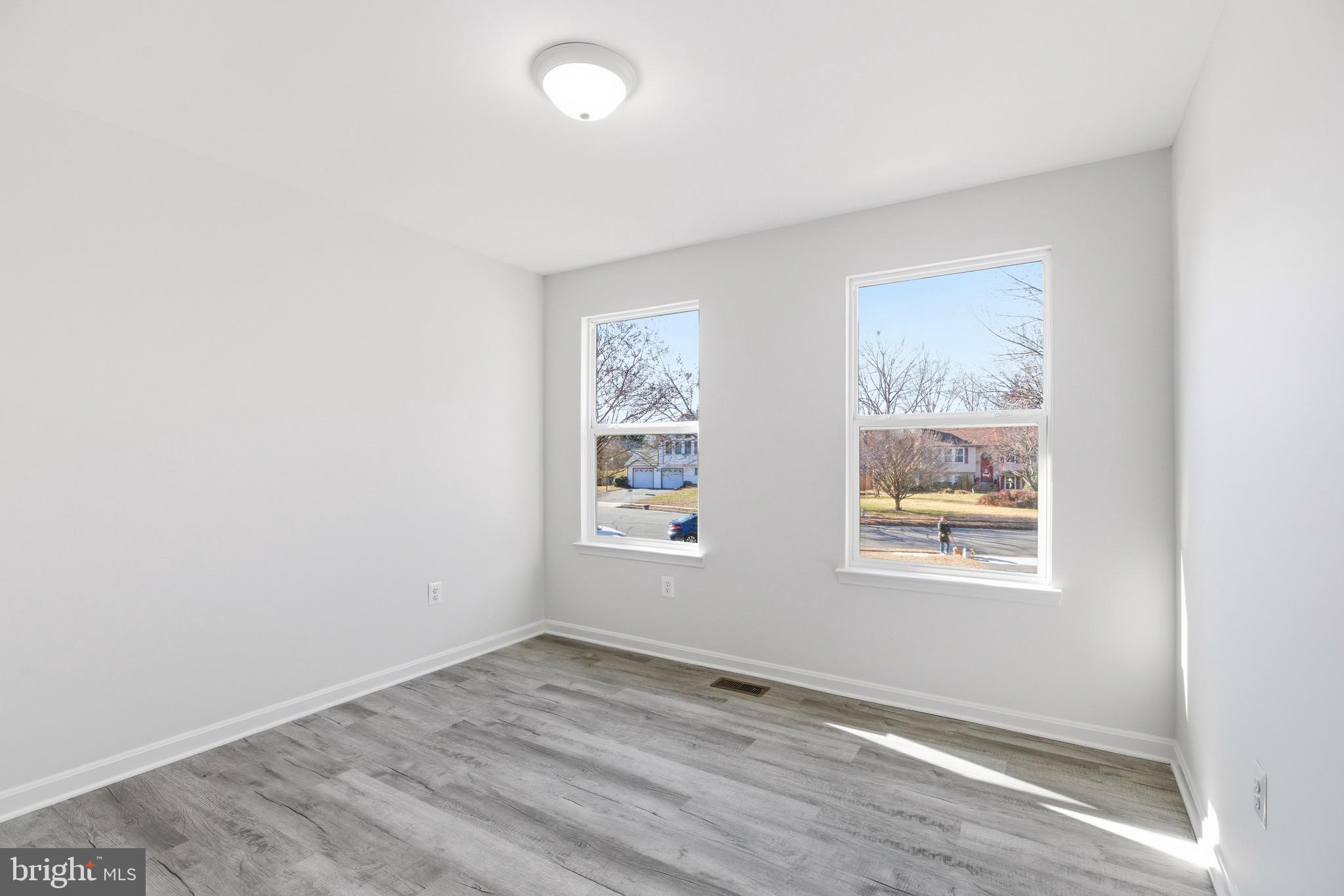 10395 Janja Court Manassas, VA 20110 - Photo 19 of 44 an empty room with wooden floor and windows