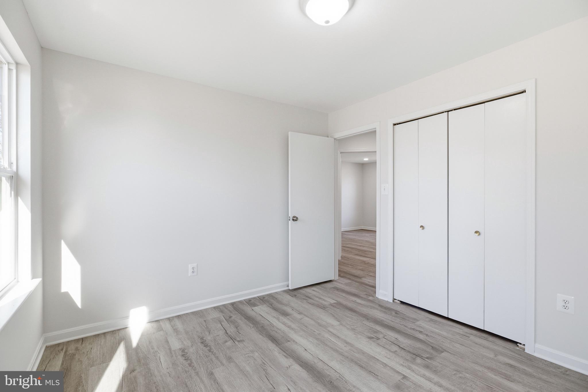10395 Janja Court Manassas, VA 20110 - Photo 20 of 44 a view of an empty room with wooden floor and a window