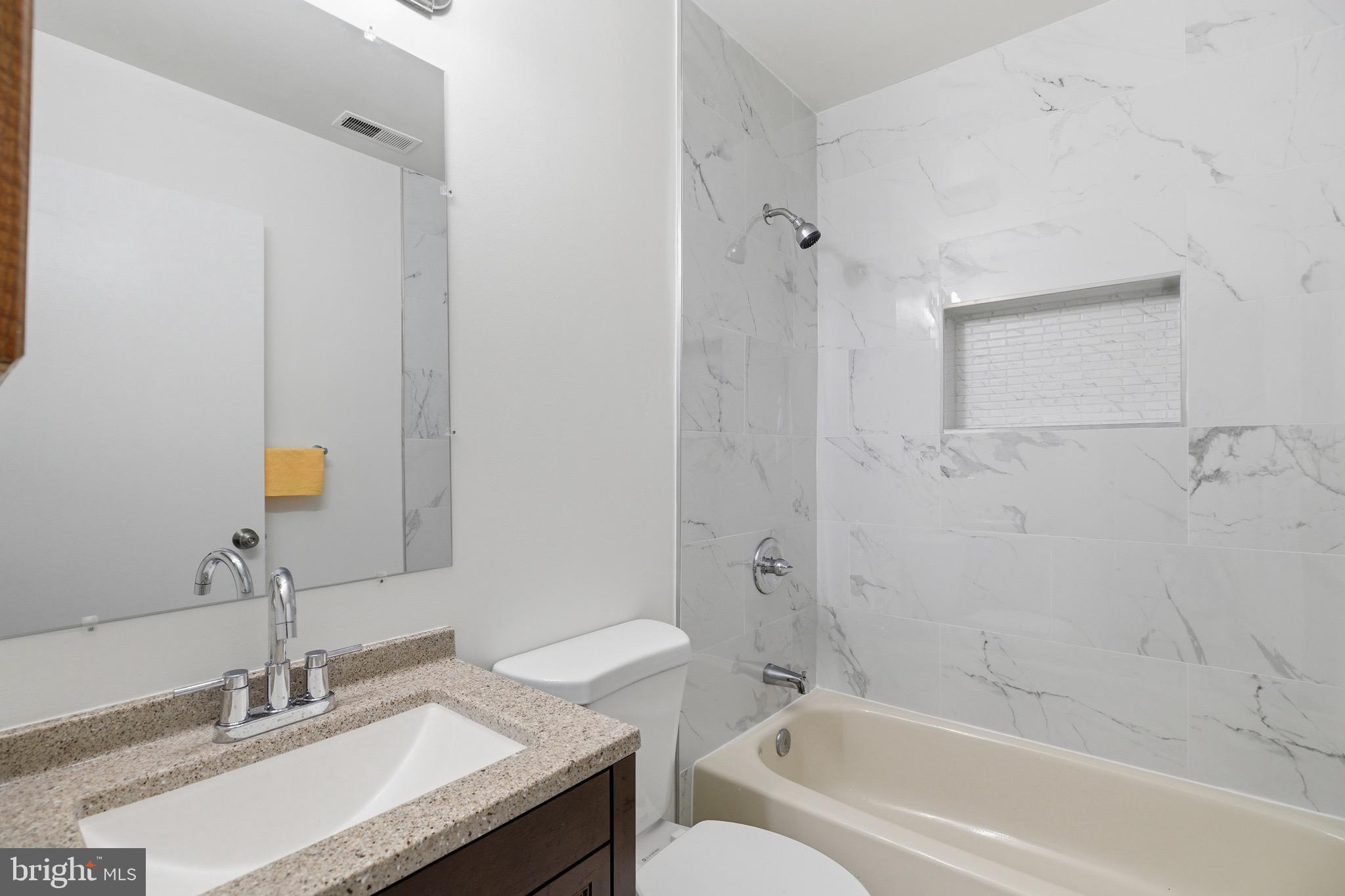 10395 Janja Court Manassas, VA 20110 - Photo 28 of 44 a bathroom with a granite countertop sink a toilet and shower