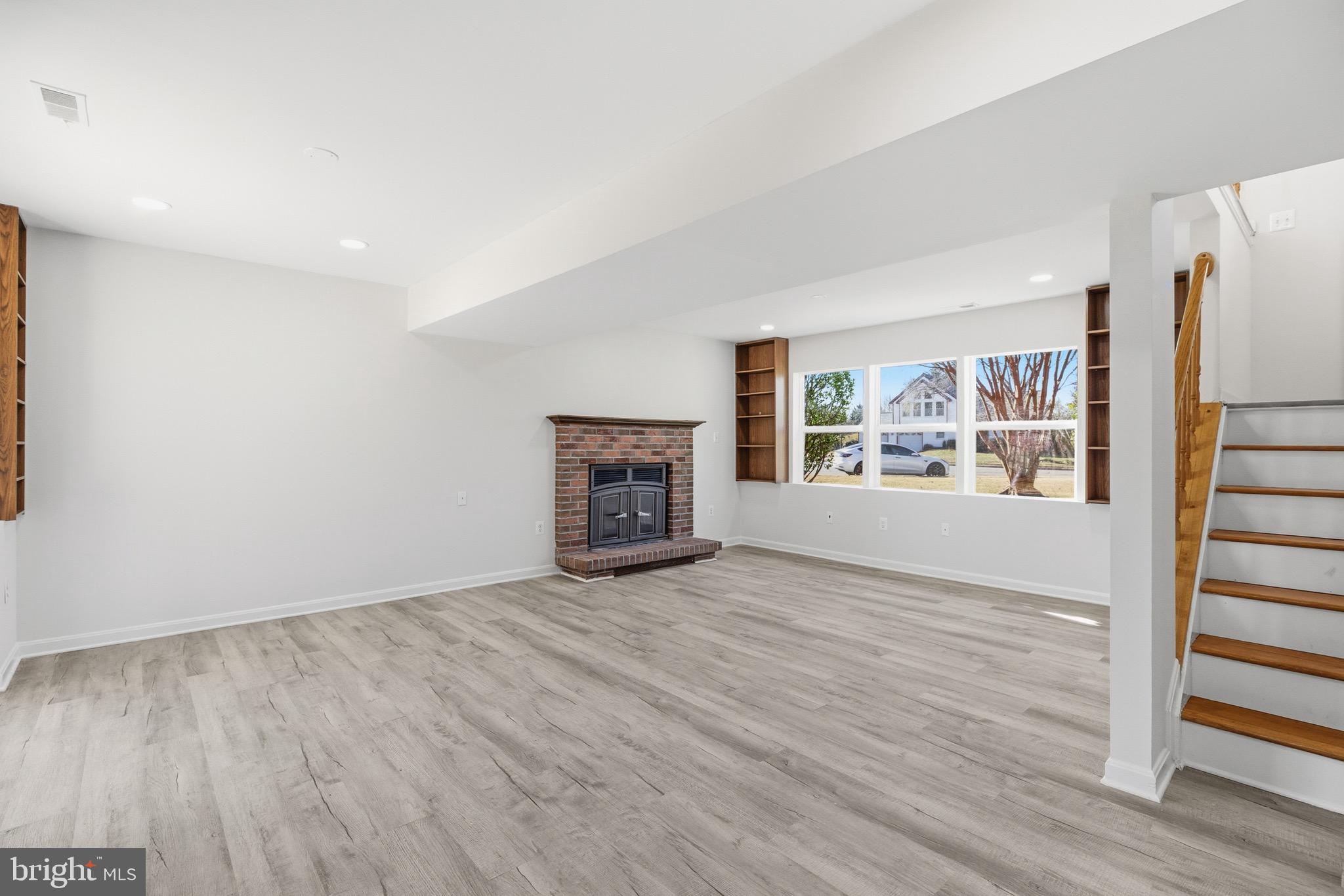 10395 Janja Court Manassas, VA 20110 - Photo 29 of 44 wooden floor fireplace and windows in an empty room