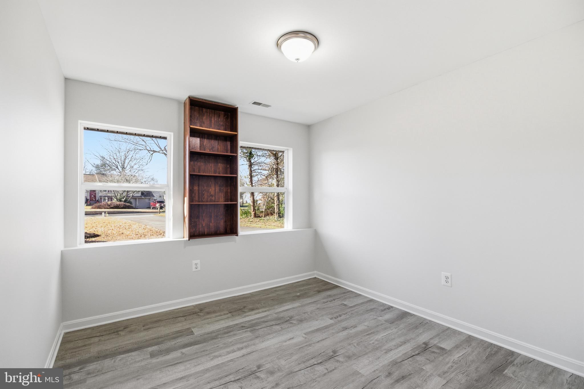 10395 Janja Court Manassas, VA 20110 - Photo 32 of 44 a view of an empty room with a window and wooden floor