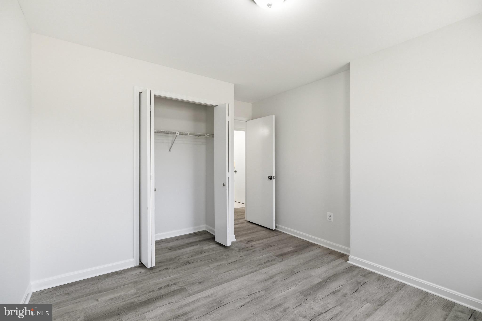 10395 Janja Court Manassas, VA 20110 - Photo 33 of 44 a view of an empty room with wooden floor and closet