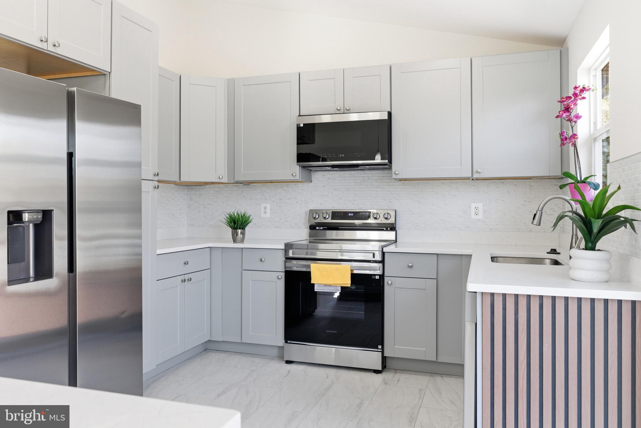 10395 Janja Court Manassas, VA 20110 - Photo 10 of 44 a kitchen with stainless steel appliances white cabinets and a sink