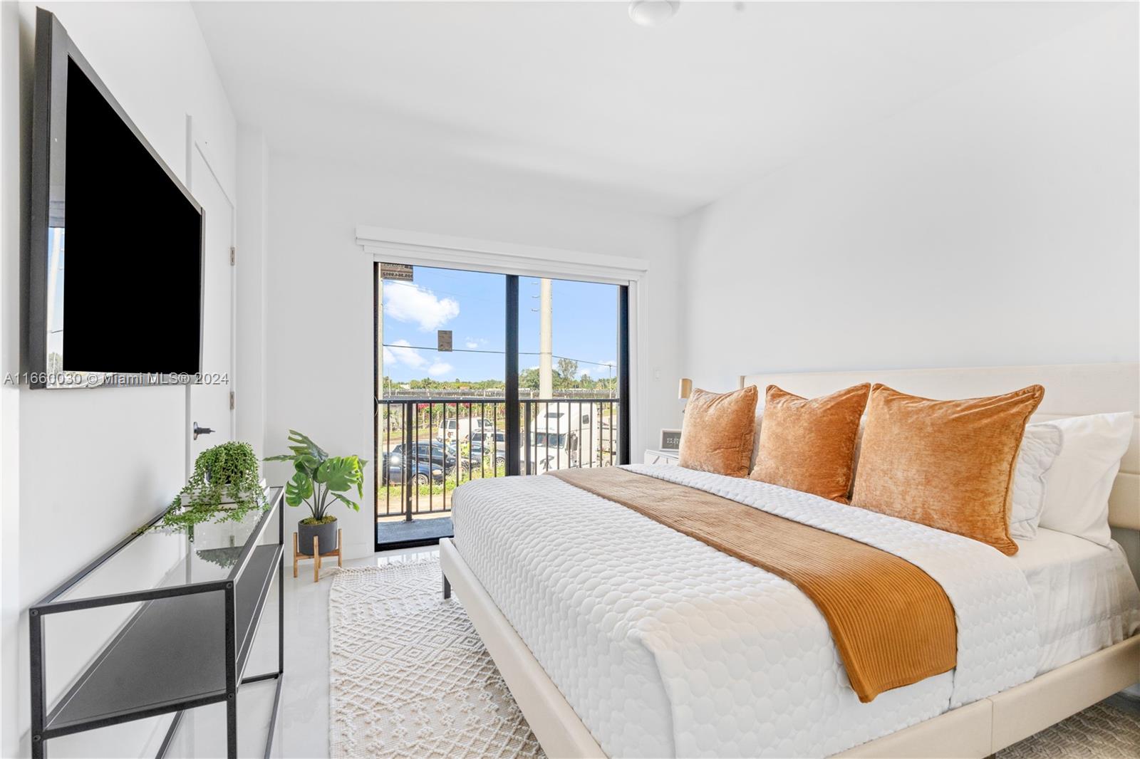 26119 Southwest 145th Court Homestead, FL 33033 - Photo 12 of 25 a bedroom with a bed and a flat screen tv