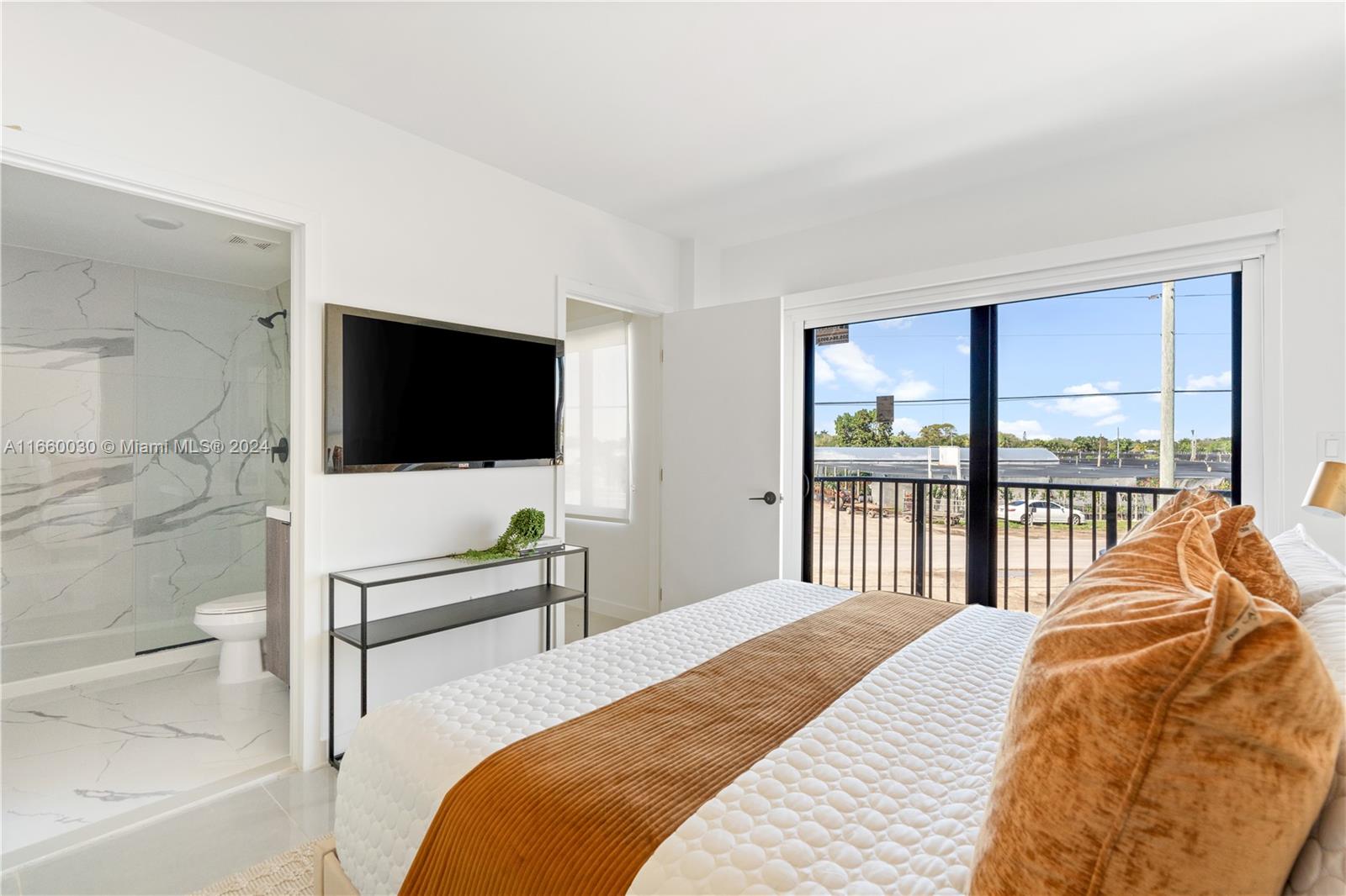 26119 Southwest 145th Court Homestead, FL 33033 - Photo 14 of 25 a bedroom with a bed and a flat screen tv