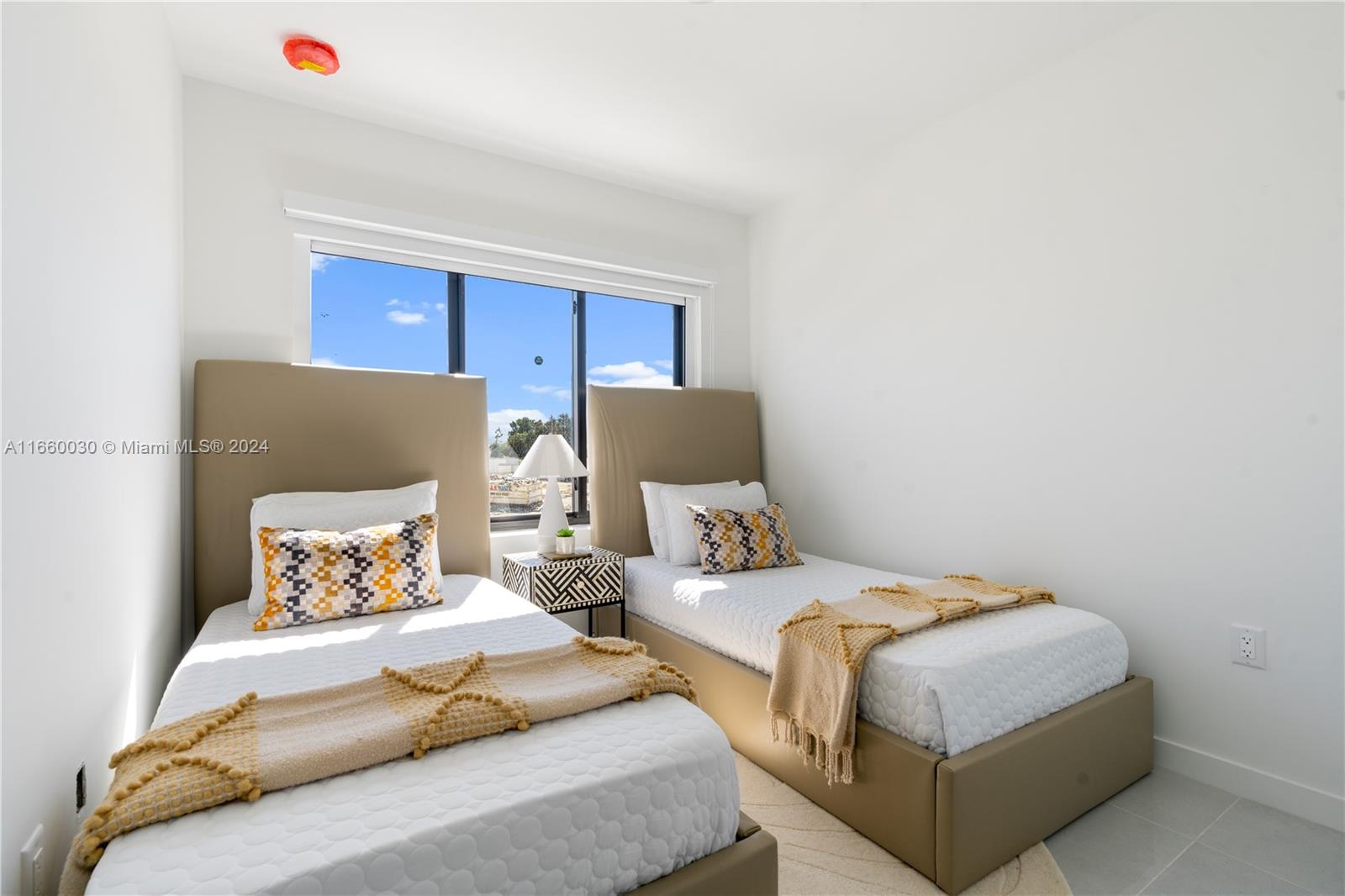 26119 Southwest 145th Court Homestead, FL 33033 - Photo 23 of 25 a bedroom with two beds and a window