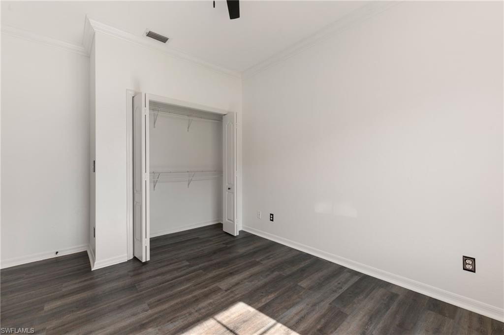 223 Stanhope Circle Naples, FL 34104 - Photo 23 of 41 Interior space featuring wood-finish flooring, white baseboards, and white walls