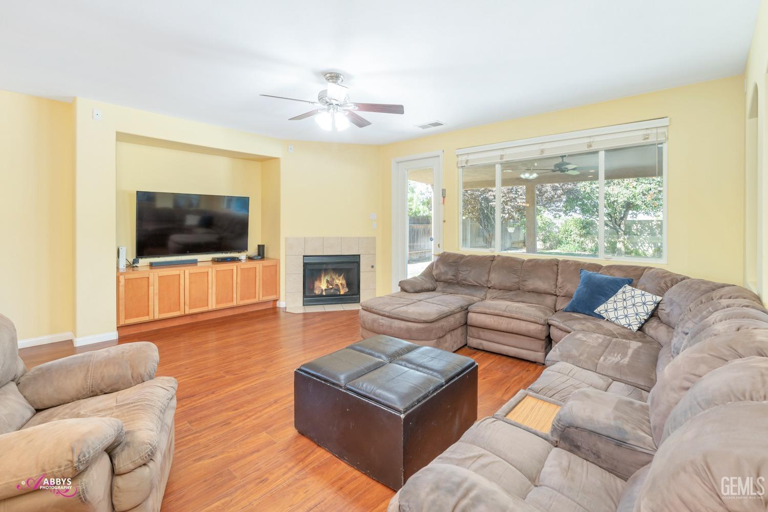 Undisclosed Address Bakersfield, CA 93312 - Photo 9 of 53 Family room with built-in cabinets, door to covered patio