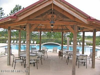 8612 Ribbon Falls Lane Jacksonville, FL 32244 - Photo 12 of 13 a view of a patio with a table and chairs under an umbrella