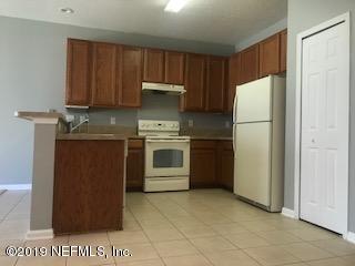 8612 Ribbon Falls Lane Jacksonville, FL 32244 - Photo 3 of 13 a kitchen with a stove top oven and refrigerator