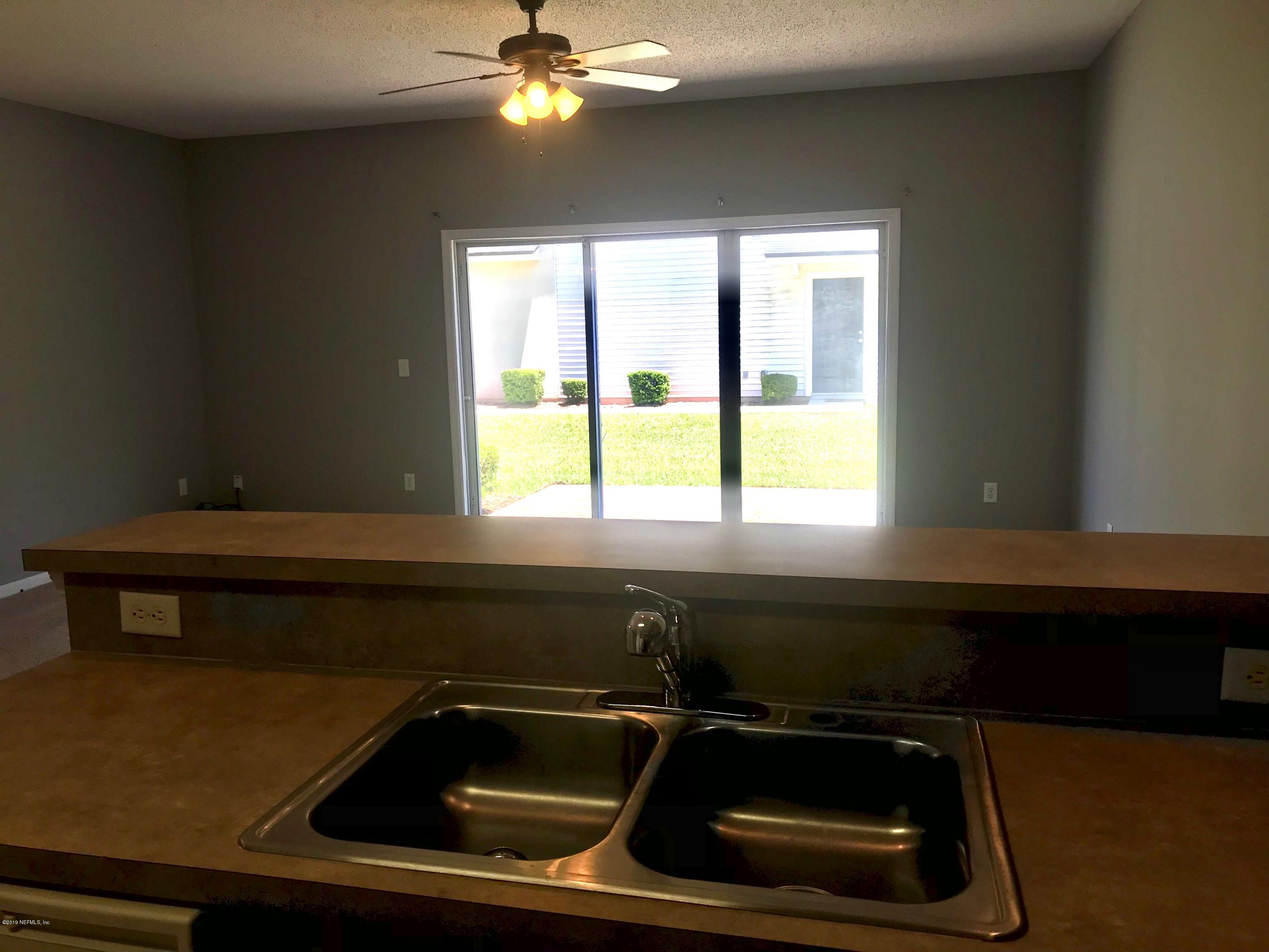 8612 Ribbon Falls Lane Jacksonville, FL 32244 - Photo 4 of 13 a kitchen that has a sink and a stove