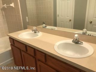8612 Ribbon Falls Lane Jacksonville, FL 32244 - Photo 9 of 13 a bathroom with a sink and a mirror