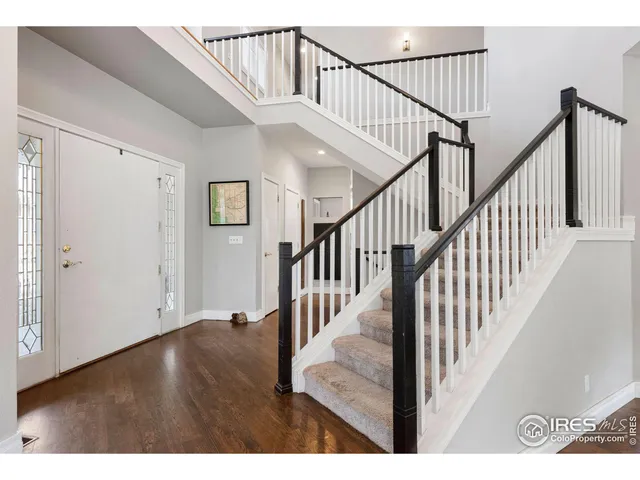 a view of staircase with railing and white walls