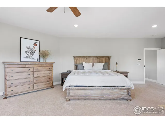 a bedroom with a bed and a painting on the wall