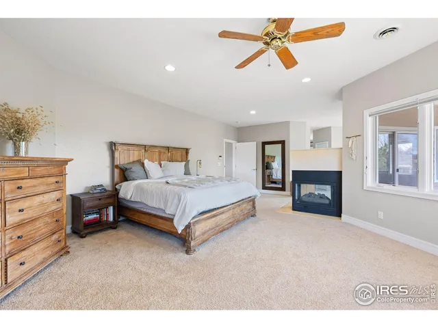 a bedroom with a bed chandelier painting on the wall and a chandelier
