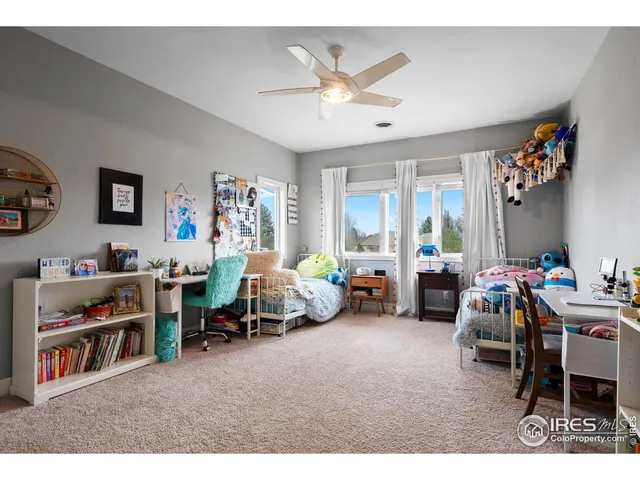 a living room with furniture and a book shelf