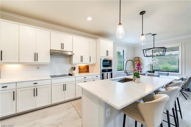 a kitchen with appliances a sink and cabinets