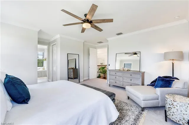 a bedroom with a bed a couch and a painting on the wall