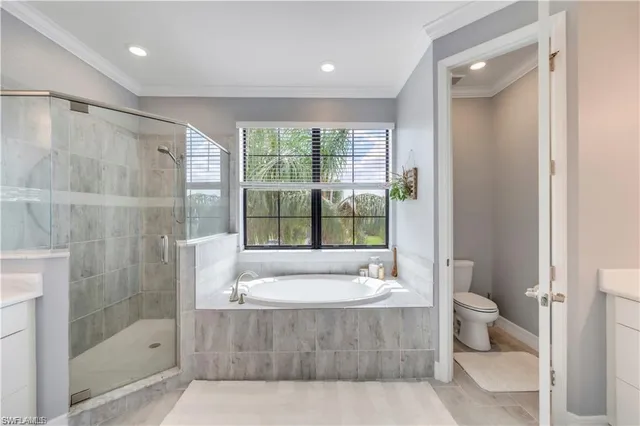 a bathroom with a tub shower sink and mirror