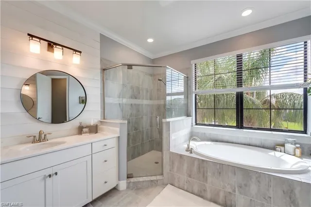 a bathroom with a tub sink and mirror