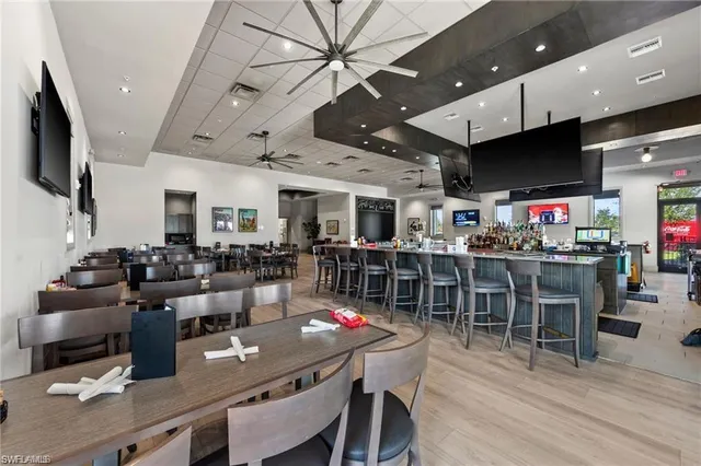 a living room with lots of furniture and kitchen