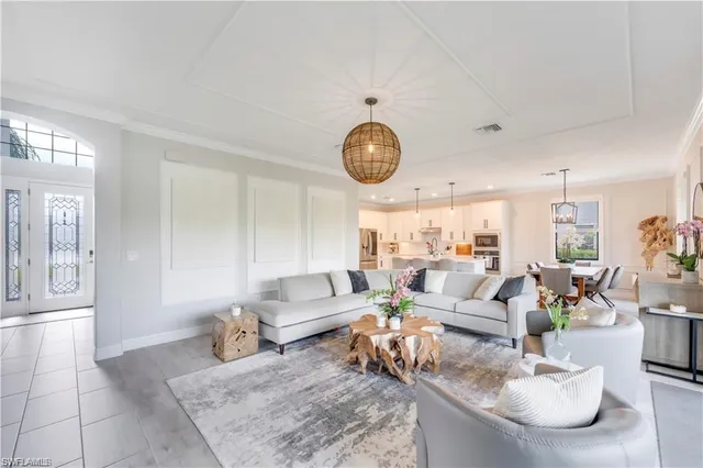 a living room with furniture and a clock