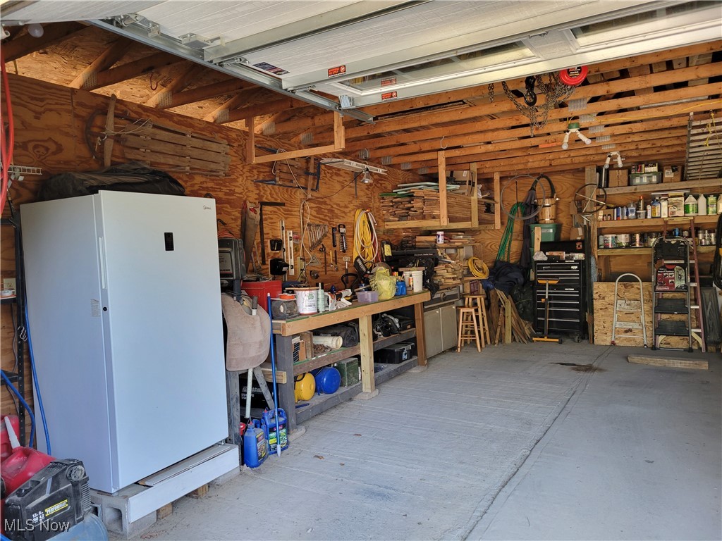85645 Merryman Road Cadiz, OH 43907 - Photo 26 of 38 Garage featuring white fridge and a workshop area