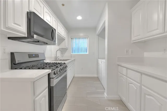 a kitchen with stainless steel appliances granite countertop a stove and a sink