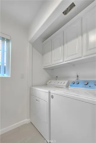 a utility room with sink dryer and washer