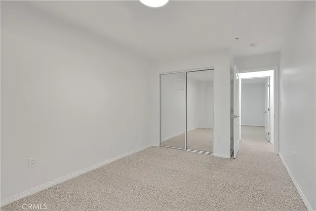 a view of a hallway with a livingroom and a window