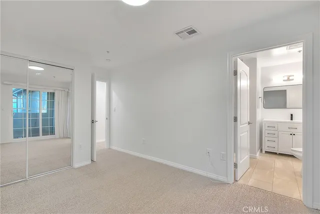 a bathroom with a toilet a sink a vanity and mirror