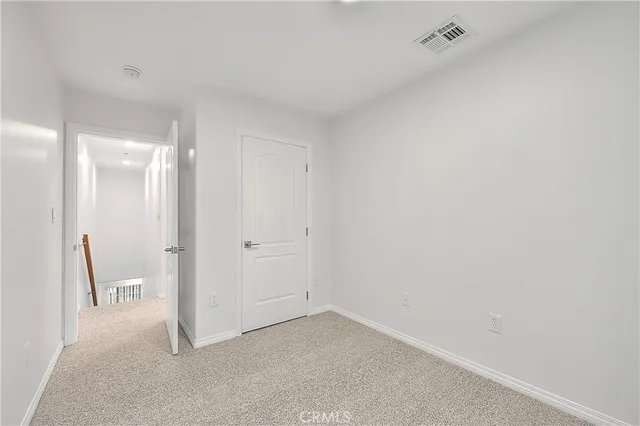 a view of a hallway with windows and entryway