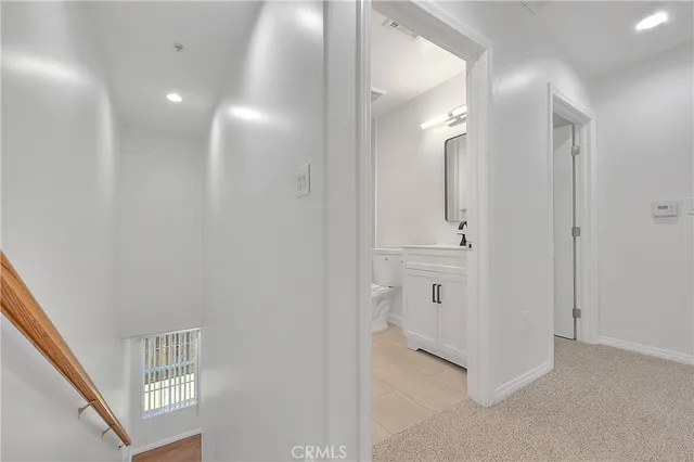 a bathroom with a sink a toilet a mirror and shower