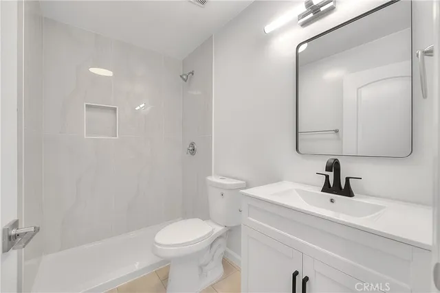 a white toilet sitting next to a bath tub